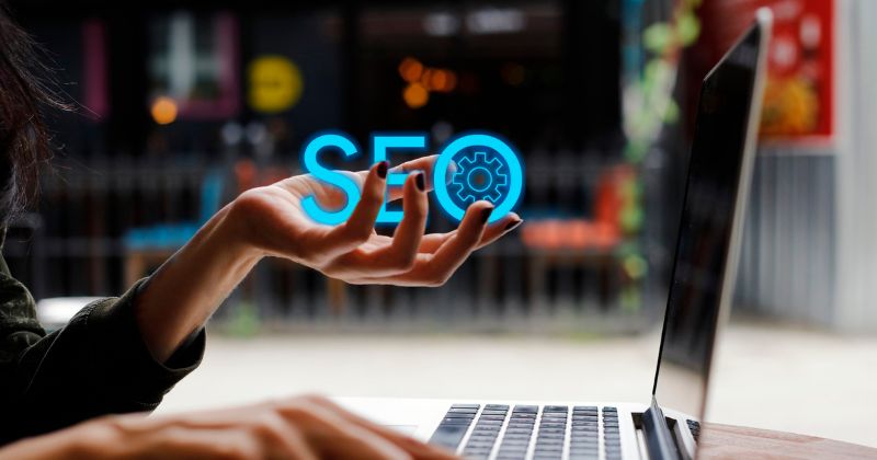 The word "SEO" floating, held by a person.